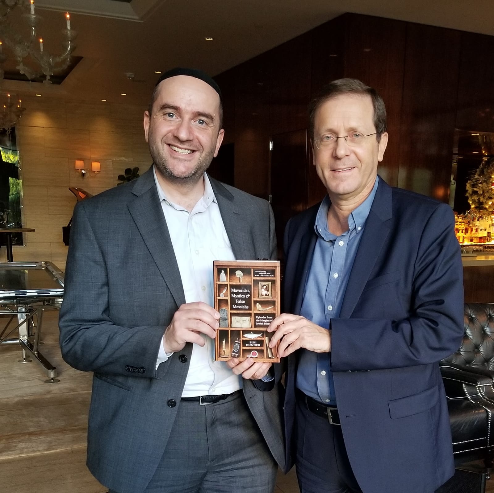 Jewish Agency Chairman Isaac "Buji" Herzog receives his copy of Rabbi Dunner's book Mavericks, Mystics & False Messiahs, at his hotel in Los Angeles, December 2, 2018