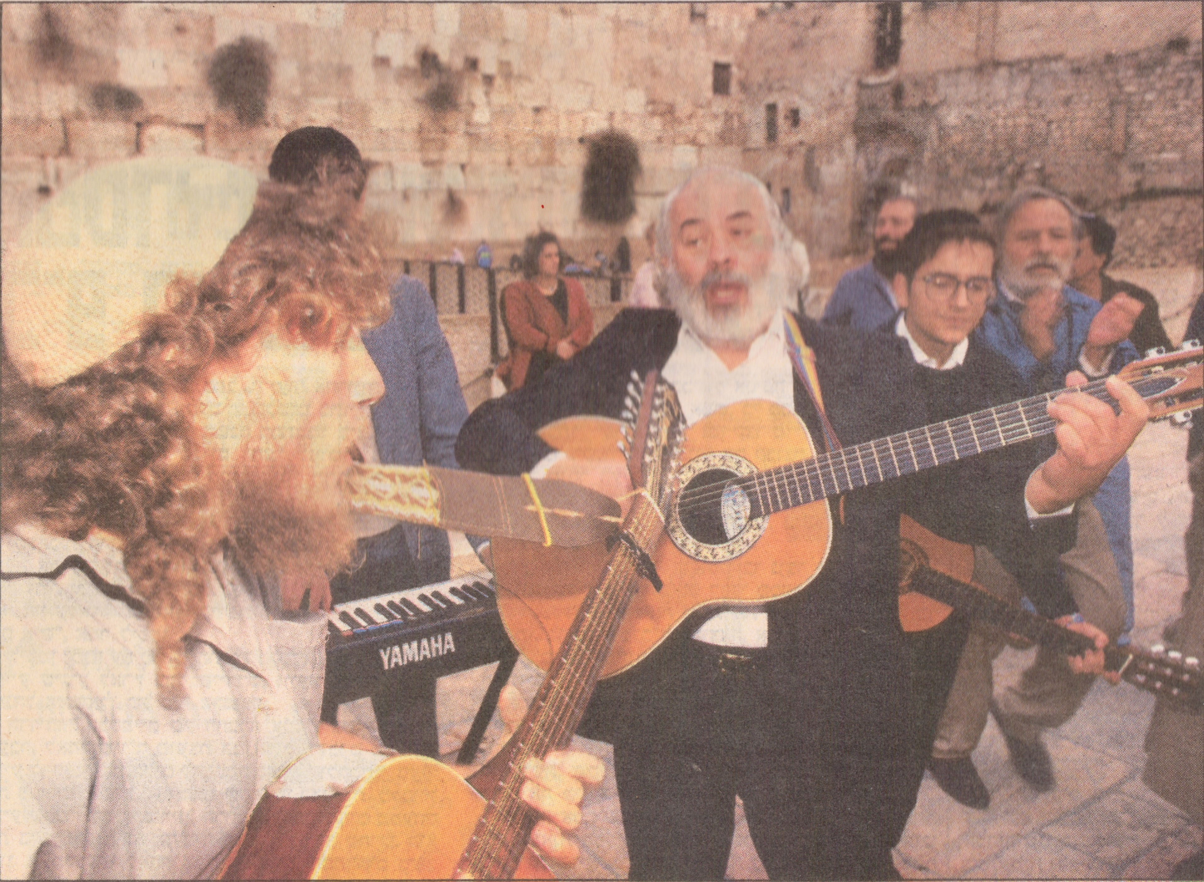 Rabbi Dunner accompanies the late Rabbi Shlomo Carlebach on his guitar for an impromptu concert at the Kotel (1990)